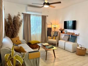 a living room with a couch and a table at Stylish Apartments - FREE Bikes, Nice Area & Cozy Patio, 10 Minutes to Airport in Belize City