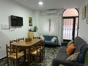 a living room with a table and a blue couch at Todimer Costa Peñon in Torrenueva