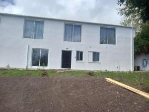 a white house with a lot of windows at CdR Casa do Rei in Lajes das Flores