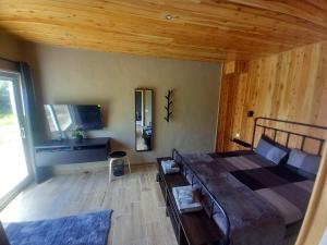 a bedroom with a large bed and a large window at CdR Casa do Rei in Lajes das Flores