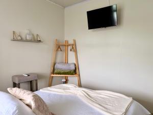 a room with a bed and a television on a wall at Casa Boho in Quesada
