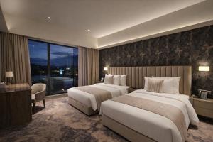 a hotel room with two beds and a window at Colombo International Airport Hotel in Katunayaka +34 photos