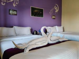 two beds in a room with a towel on them at Tiger wildlife camp in Sauraha