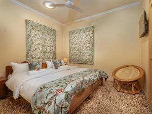 a bedroom with a large bed and a fan at Luxury Ashok Cottage in Srinagar