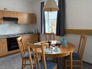 a kitchen with a wooden table and chairs and a table and a table at Glück Auf in Goslar