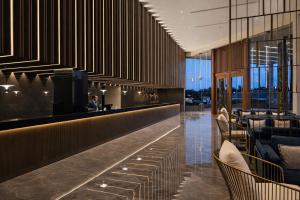 a lobby of a hotel with a bar at Colombo International Airport Hotel in Katunayaka