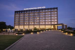 a large building with a lit up facade at night at Colombo International Airport Hotel in Katunayaka