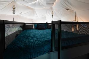 a bedroom with a bed in a tent at Līgo glamping in Stacija Meitene