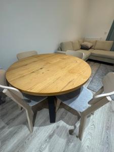 a wooden table and chairs in a living room at Blissful Abode in Birmingham