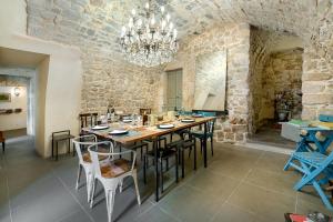 a dining room with a large wooden table and chairs at Iblainsuite in Ragusa