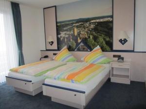 Postel nebo postele na pokoji v ubytování Hotel zur Burg Nürburg