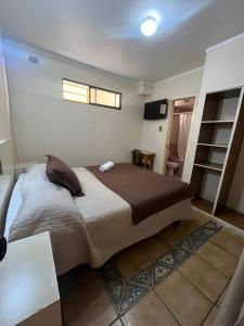 a bedroom with a large bed and a window at Hotel Brasil in Antofagasta +14 photos