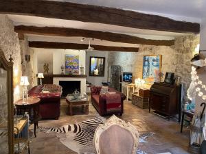 a living room filled with furniture and a fireplace at Ma Maison in Vence