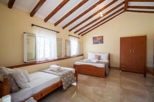 a bedroom with two beds in a room at Potami Studios in Lefkimmi