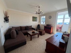 a living room with a couch and a table at Appartementhaus, Villa Katharina, Sassnitz in Sassnitz