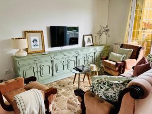 a living room with a television on top of a dresser at CASA LUMERMA in Taboadela
