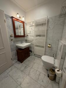 a bathroom with a toilet and a sink at Appartementhaus, Villa Katharina, Sassnitz in Sassnitz