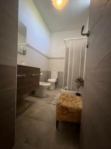 a bathroom with a toilet and a sink at Sicily Summer in Nunziata +19 photos