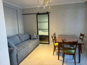 a living room with a couch and a table at Apartament Ablewicza VIP in Tarnów