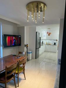 a kitchen and dining room with a table and a refrigerator at Apartament Ablewicza VIP in Tarnów