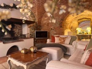 a living room with a couch and a fireplace at La Casetta Di Borgo in Lajatico