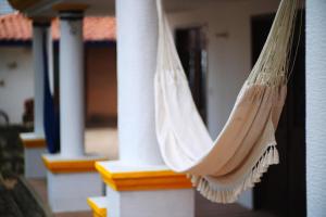 a hammock hanging on a porch of a house at Casa Aply in San Andrés Huayapan