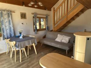a living room with a table and a couch at Chata Dolce in Trutnov +22 photos