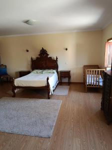 a bedroom with a bed and two rugs at Casa do Pomarelho in Póvoa de Lanhoso +15 photos