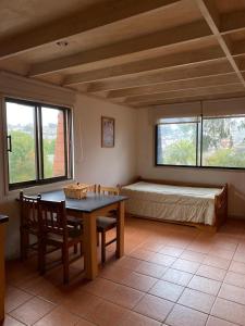 a bedroom with a bed and a table and chairs at Linda Vista Apart Hotel in Concón +44 photos