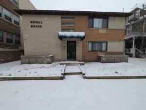 a building with snow on the ground in front of it at Spacious Studio near Brady St in Milwaukee