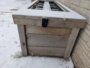 a wooden planter with snow on top of it at Spacious Studio near Brady St in Milwaukee +4 photos