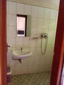 a bathroom with a sink and a window at Uhuru 50 Hotel in Kasese +23 photos