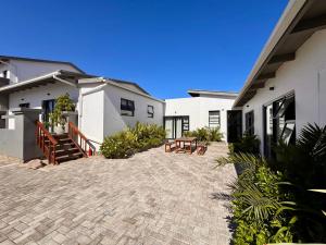 a patio outside of a house with benches at House Sworyx in Walvis Bay
