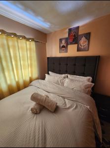 a stuffed animal laying on top of a bed at Pure excellence homes in Ruiru