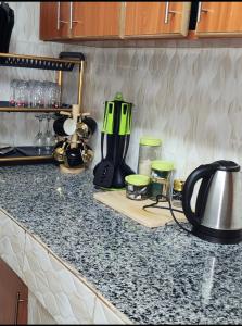 a kitchen counter with a tea kettle and other appliances at Pure excellence homes in Ruiru