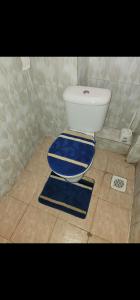 a blue and white toilet in a bathroom at Pure excellence homes in Ruiru