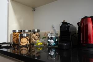 a counter with jars of food and a coffee maker at 3 Baneasa Airport in Bucharest
