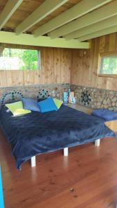 a bedroom with a large bed in a room at Cabane perchée in Mongauzy