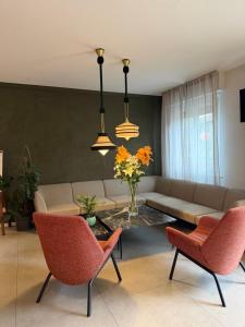 ein Wohnzimmer mit Sofa, Tisch und Stühlen in der Unterkunft Hotel Marolda in Sirmione