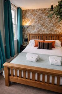 a bedroom with a bed with two towels on it at The Union Inn in Cowes