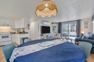 a living room with a blue bed and a kitchen at Cornish Cottage Walk to Long Sands Beach in York +27 photos