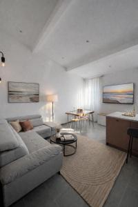 a living room with a couch and a table at Trianon Location in Bagnols-en-Forêt