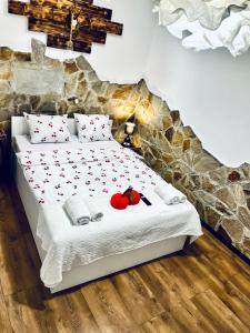 a bedroom with a bed with red apples on it at Agro Bieszczady Sleep Tourism in Czarna