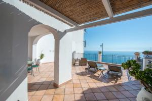 a patio with chairs and a view of the ocean at Casa Marina in Praiano