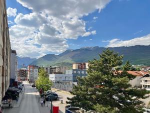 a view of a city with mountains in the background at 2001 Central Stay in Peje