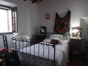 a bedroom with a bed and a dresser and a window at Ferreira do Alentejo Terrace Rustic Villa in Beja +35 photos