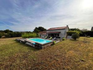 a house with a swimming pool in a yard at Fontaine de Champagne in Champagne-et-Fontaine