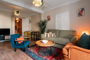 a living room with a couch and a table at Stylish Harbourfront Apartment in Torquay