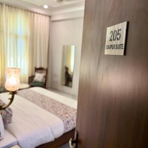 a bedroom with a bed and a sign on a door at Chitawa Haveli A Luxury Heritage Hotel in Jaipur