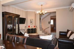 a living room with a couch and a table at Calm Breeze House in Nea Peramos